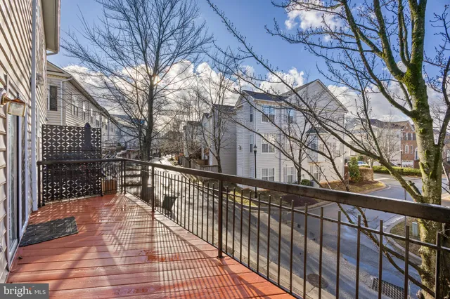a view of a patio with table and chairs with wooden floor and fence