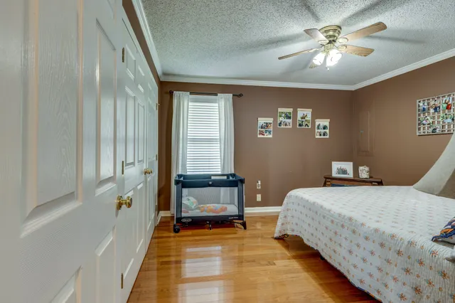 a bedroom with a large bed and a chandelier
