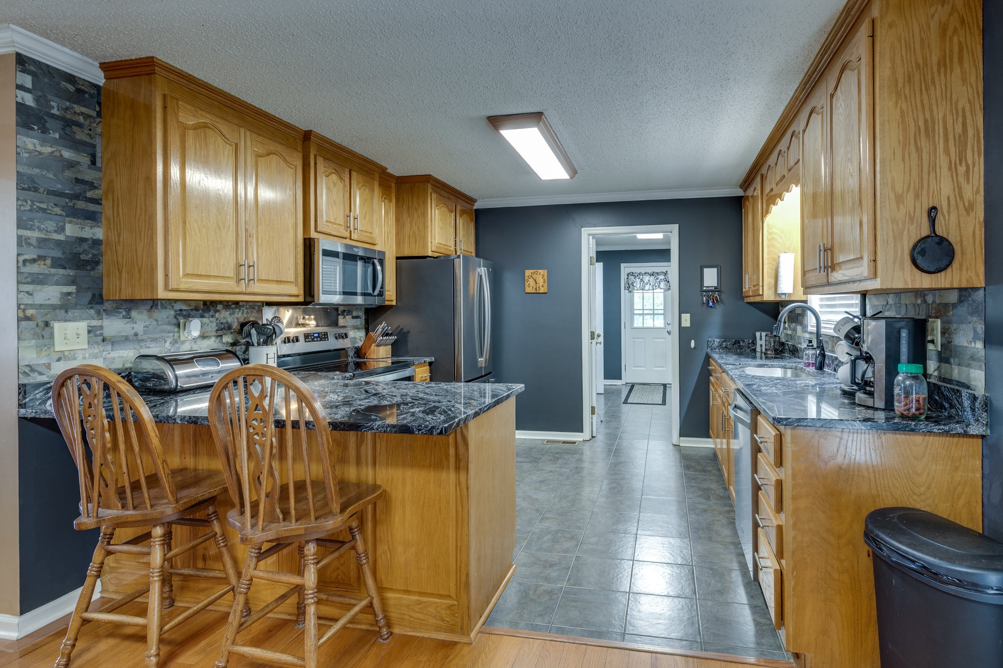 353 Major Road Cornersville, TN 37047 - Photo 7 of 74 a kitchen with stainless steel appliances kitchen island granite countertop a table chairs in it and a window