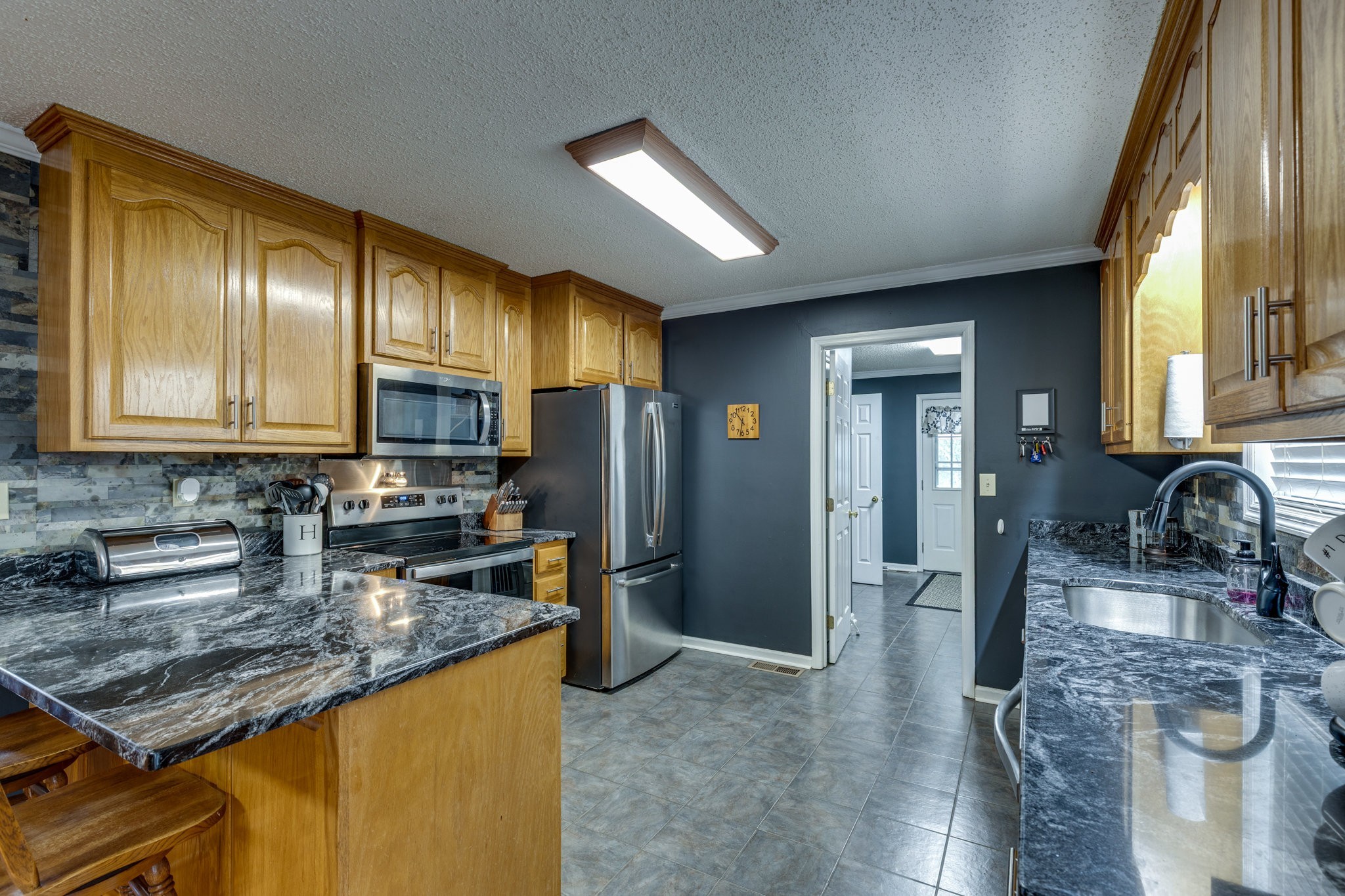 353 Major Road Cornersville, TN 37047 - Photo 8 of 74 a kitchen with stainless steel appliances granite countertop refrigerator sink and stove