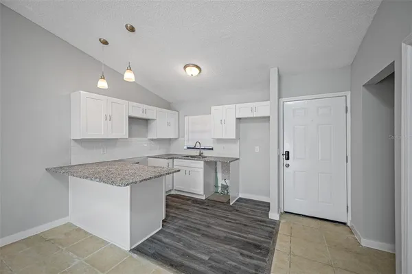 a kitchen with stainless steel appliances granite countertop a stove and a sink