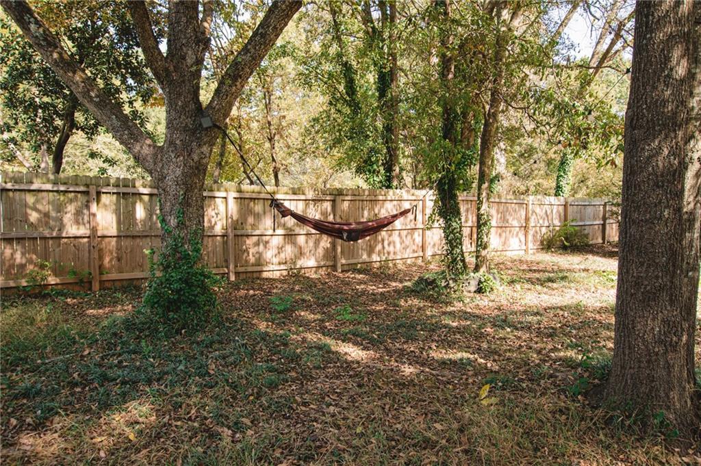 721 Davis Street Monroe, GA 30655 - Photo 19 of 20 a view of a yard in front of a house with a large tree