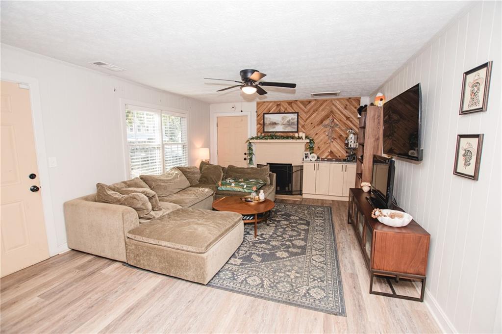 721 Davis Street Monroe, GA 30655 - Photo 4 of 20 a living room with furniture a flat screen tv and a window