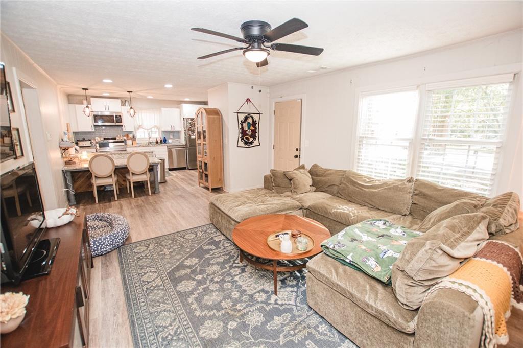 721 Davis Street Monroe, GA 30655 - Photo 6 of 20 a living room with furniture a flat screen tv and a large window