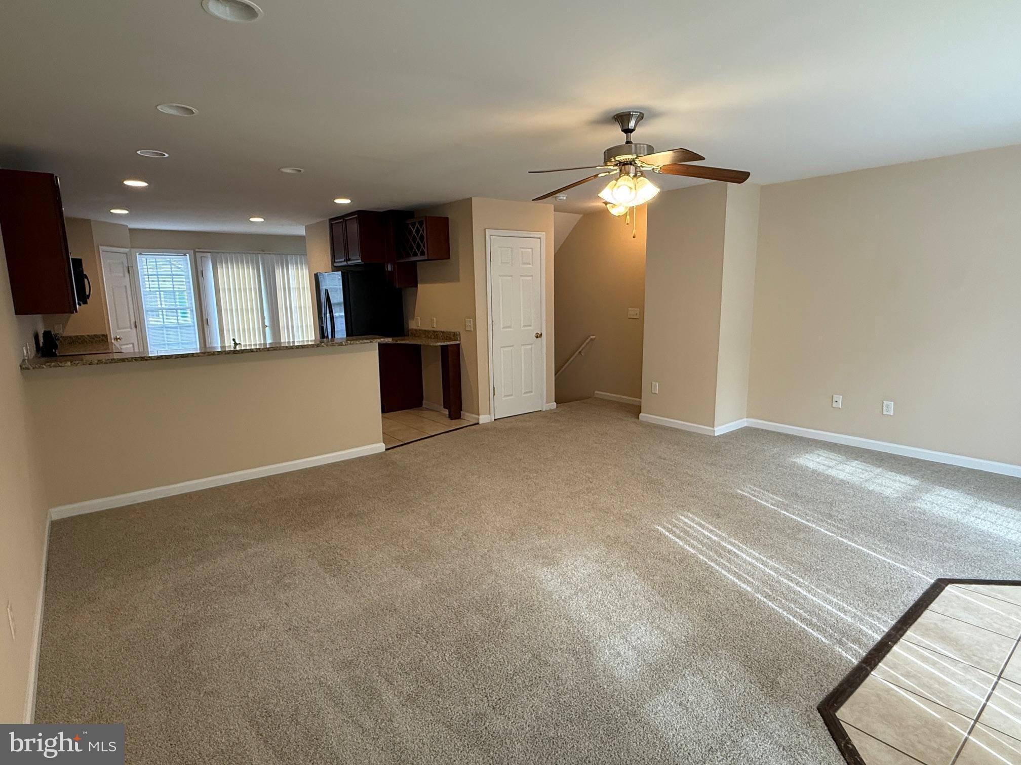 202 Bell Tower Court Stafford, VA 22554 - Photo 13 of 20 a view of a livingroom with a ceiling fan window and a kitchen