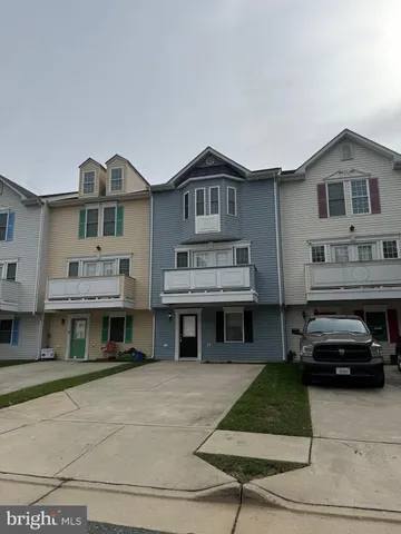 a front view of a house with a cars parked in front of it