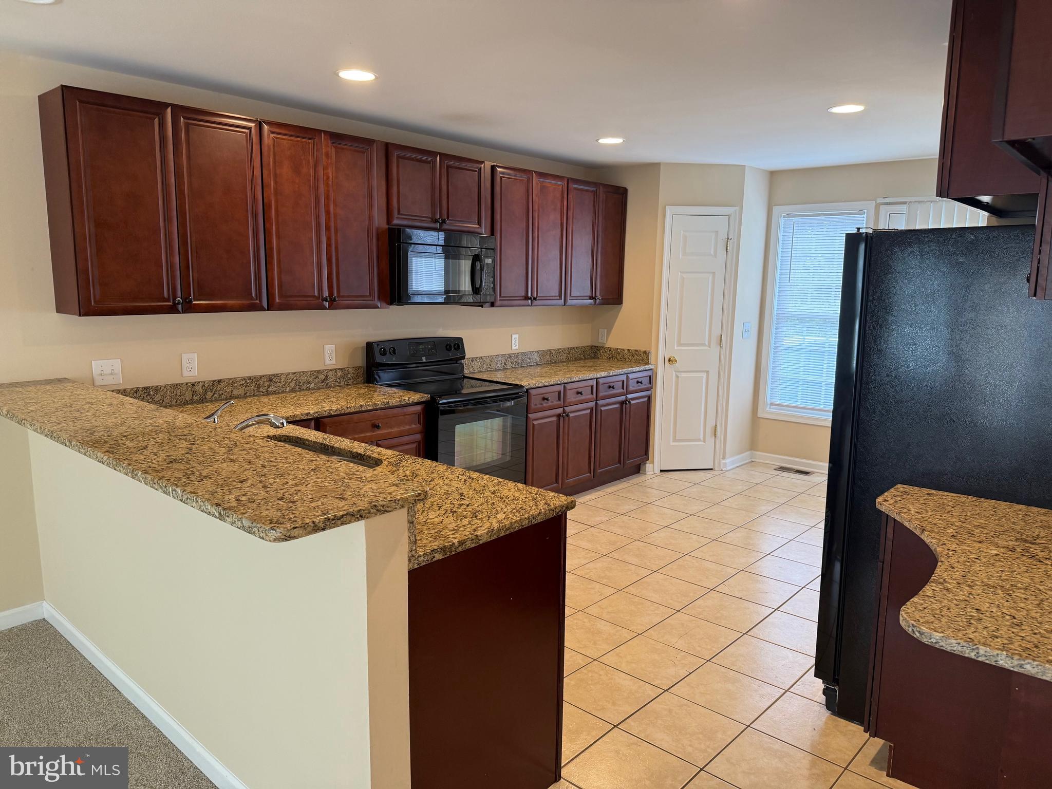 202 Bell Tower Court Stafford, VA 22554 - Photo 8 of 20 a kitchen with stainless steel appliances granite countertop a stove a sink and a refrigerator