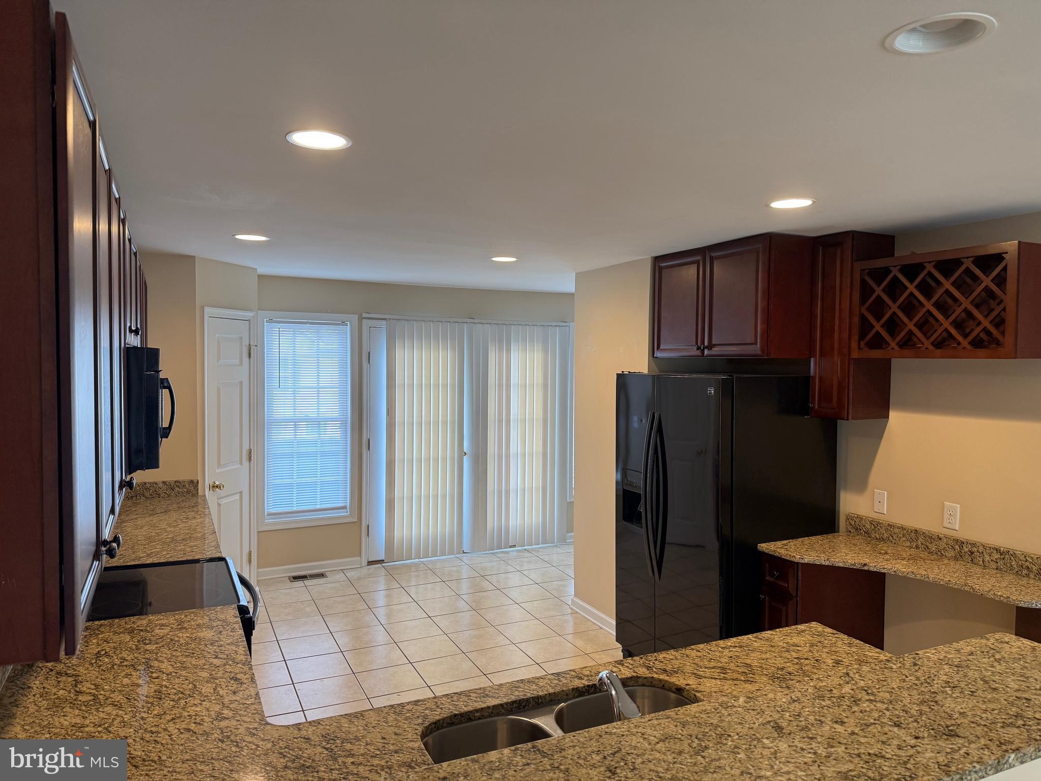 202 Bell Tower Court Stafford, VA 22554 - Photo 9 of 20 a view of hallway with kitchen island and stainless steel appliances