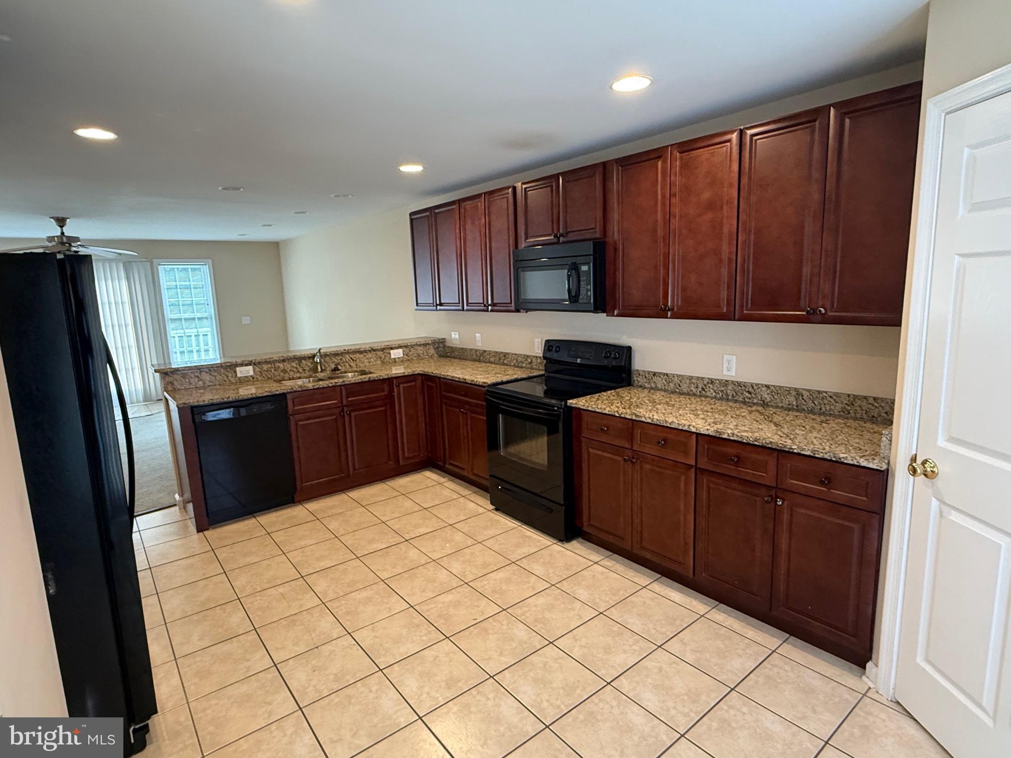 202 Bell Tower Court Stafford, VA 22554 - Photo 10 of 20 a kitchen with stainless steel appliances granite countertop a refrigerator sink and cabinets