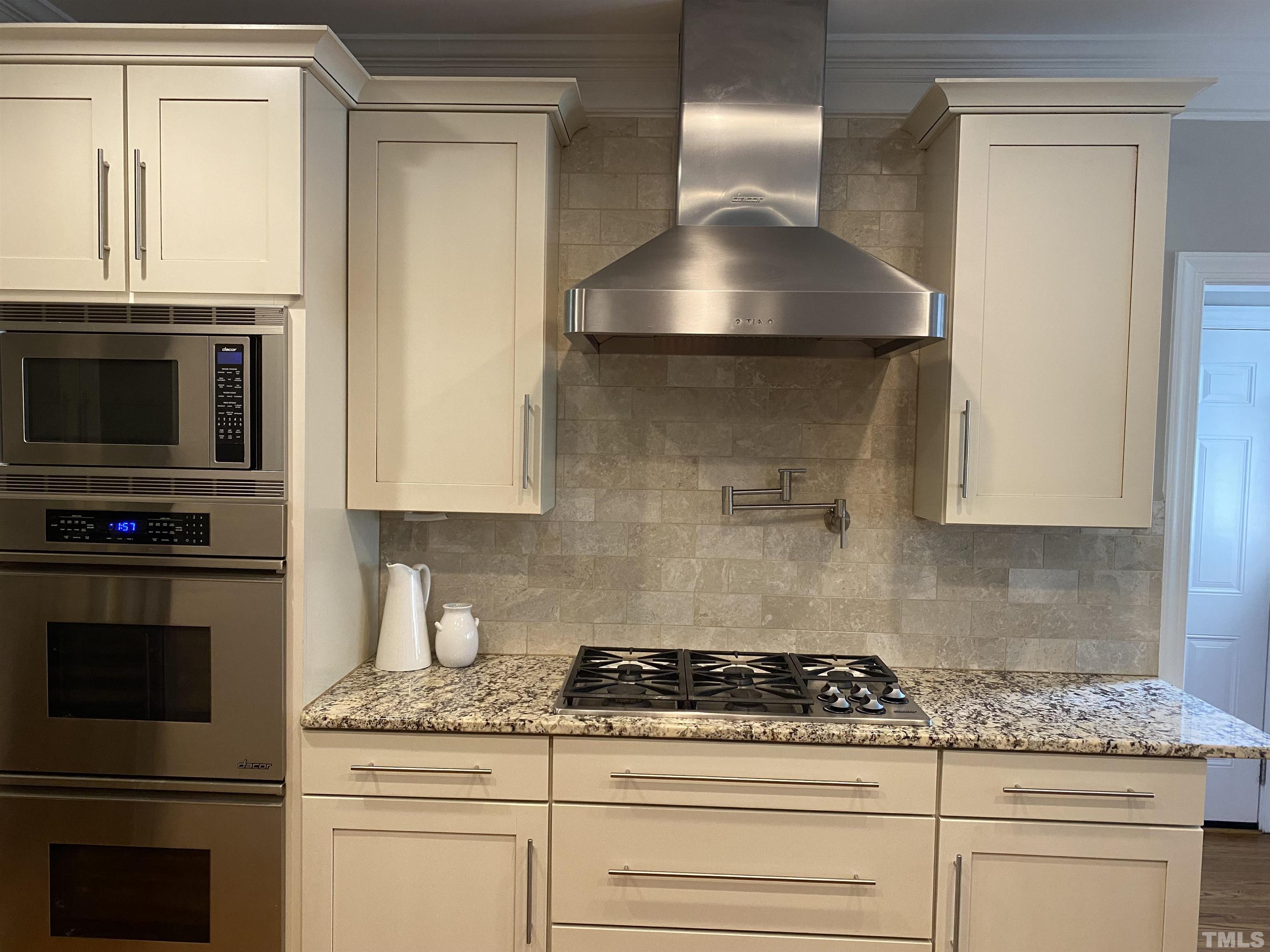 3940 White Chapel Way Raleigh, NC 27615 - Photo 5 of 40 a kitchen with granite countertop a stove and a sink