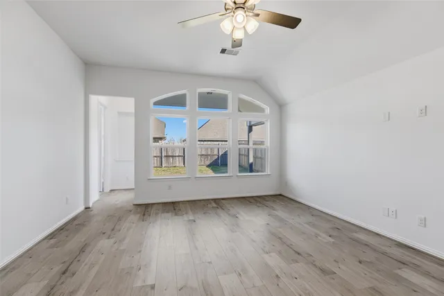 wooden floor in an empty room with a window