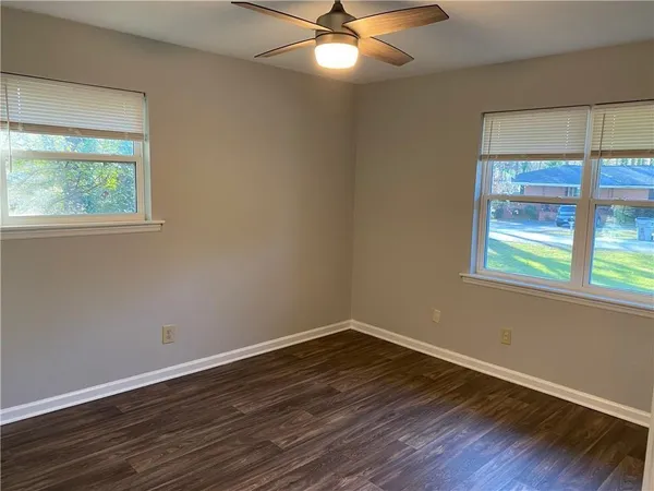 a view of a room with wooden floor and windows