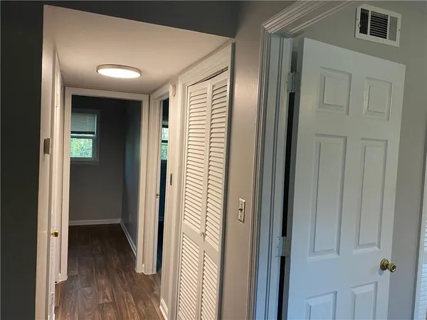 a view of a hallway with wooden floor