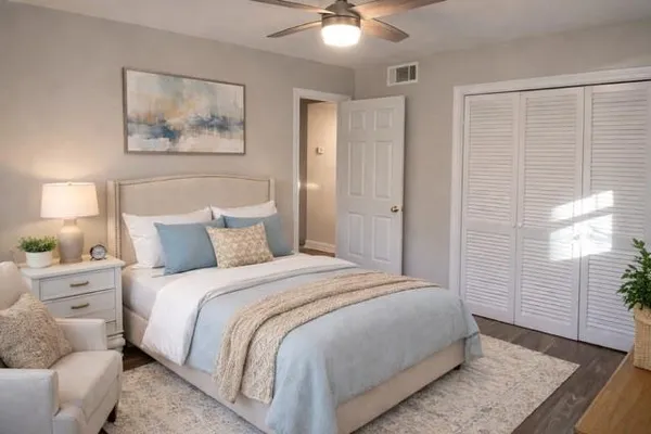 a bedroom with a bed and a painting on the wall
