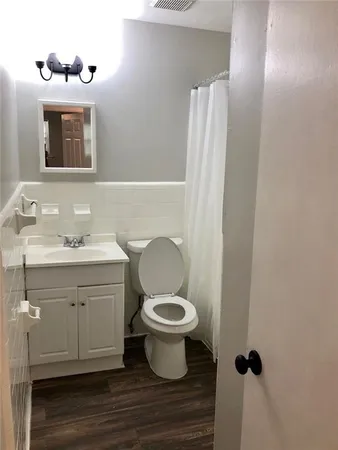 a bathroom with a sink a toilet and mirror