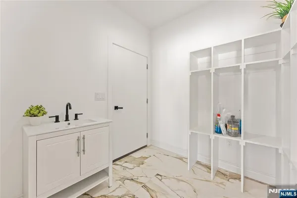 a bathroom with a sink mirror and shower