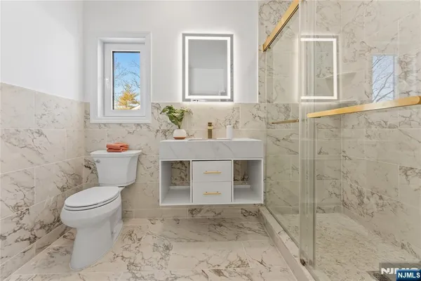 a living room with furniture a fireplace and a chandelier