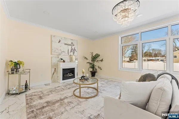 a kitchen that has a lot of cabinets in it with stainless steel appliances granite countertop a stove oven a sink dishwasher and white cabinets with wooden floor
