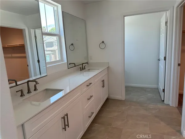 a bathroom with a double vanity sink and a mirror
