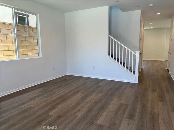 a view of a hallway with wooden floor and entryway