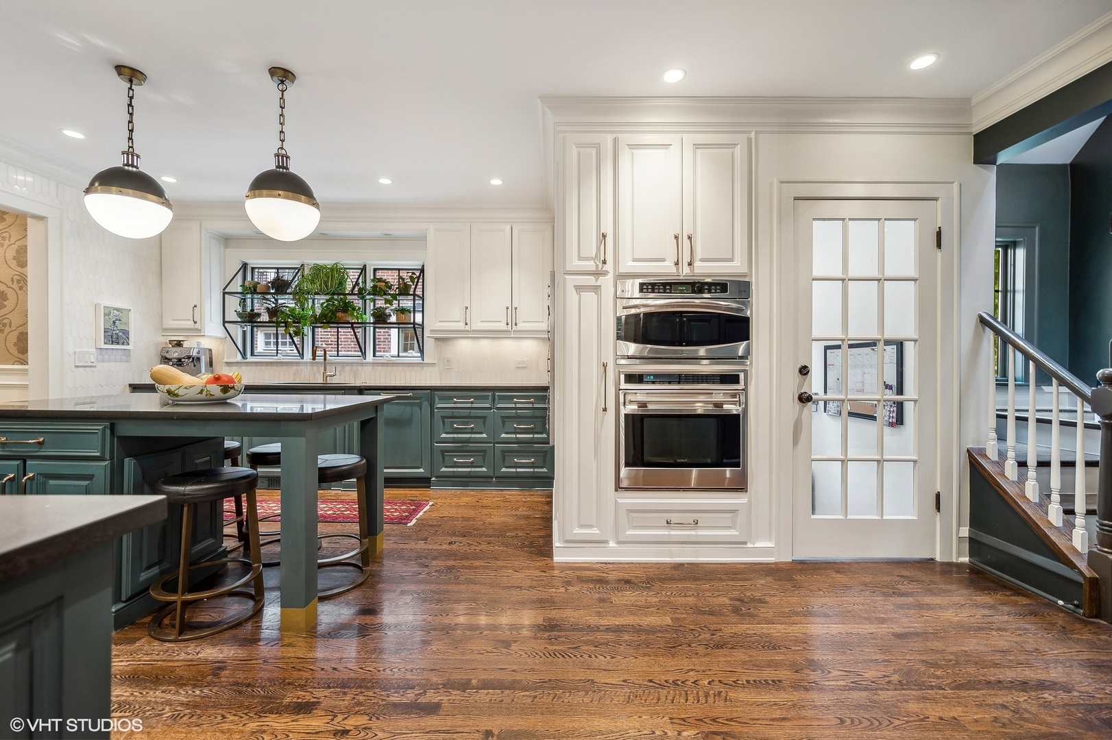 354 Elder Lane Winnetka, IL 60093 - Photo 37 of 71 a kitchen with stainless steel appliances kitchen island granite countertop a stove a refrigerator and a dining table with wooden floor