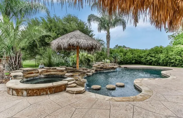 a view of a swimming pool with a patio