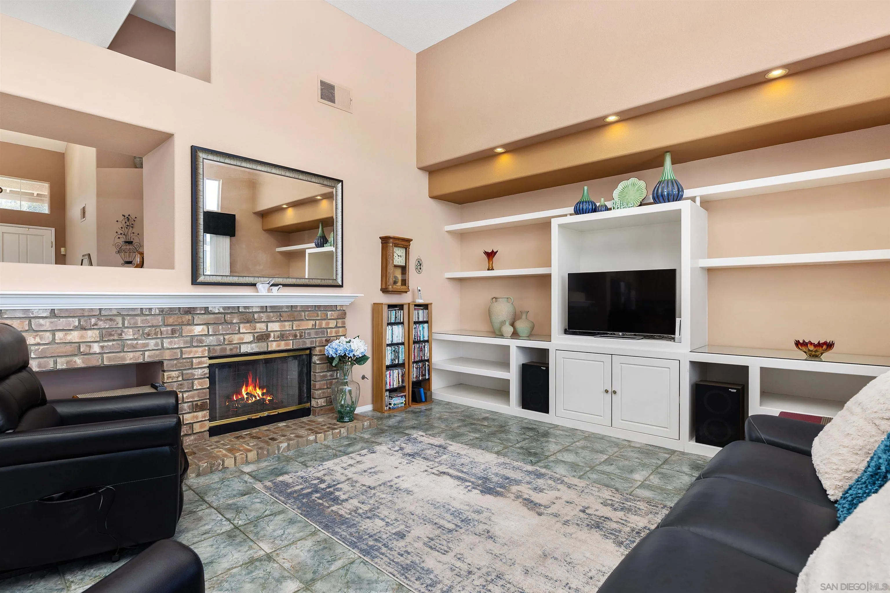 5213 Palmera Drive Oceanside, CA 92056 - Photo 13 of 38 a living room with furniture a flat screen tv and a fireplace
