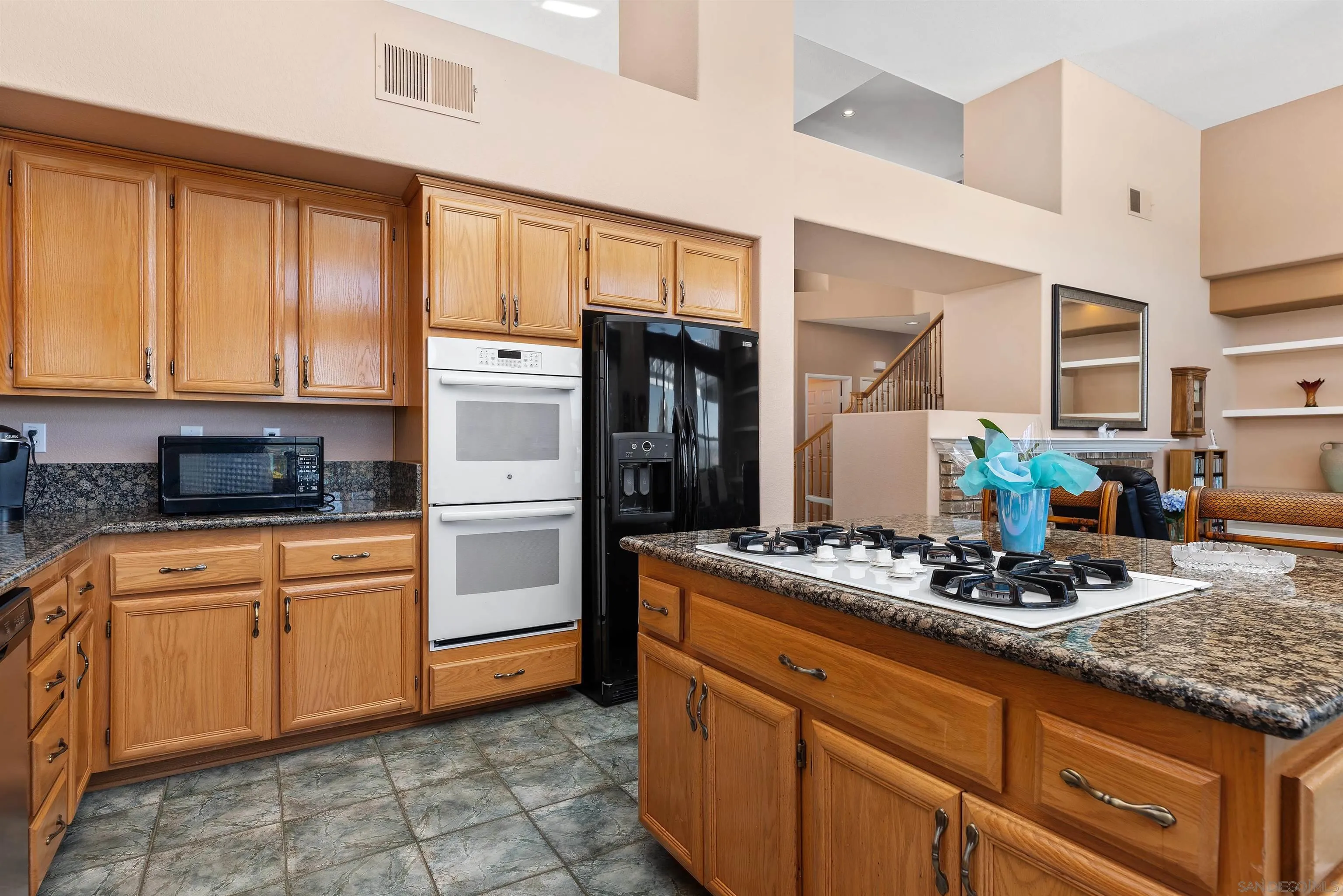 5213 Palmera Drive Oceanside, CA 92056 - Photo 17 of 38 a kitchen with stainless steel appliances granite countertop a stove sink and cabinets