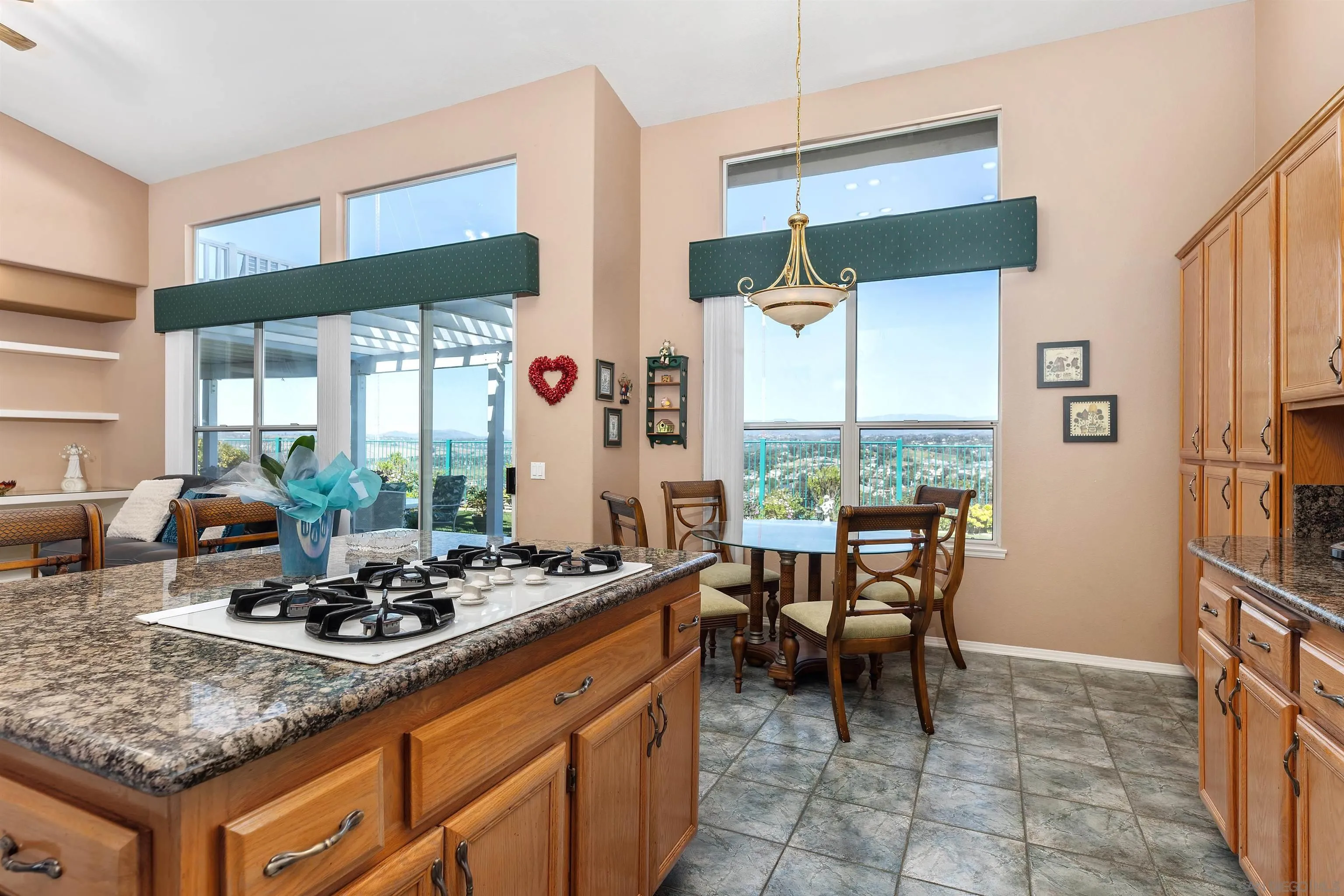 5213 Palmera Drive Oceanside, CA 92056 - Photo 18 of 38 a kitchen with a dining table chairs and a large window