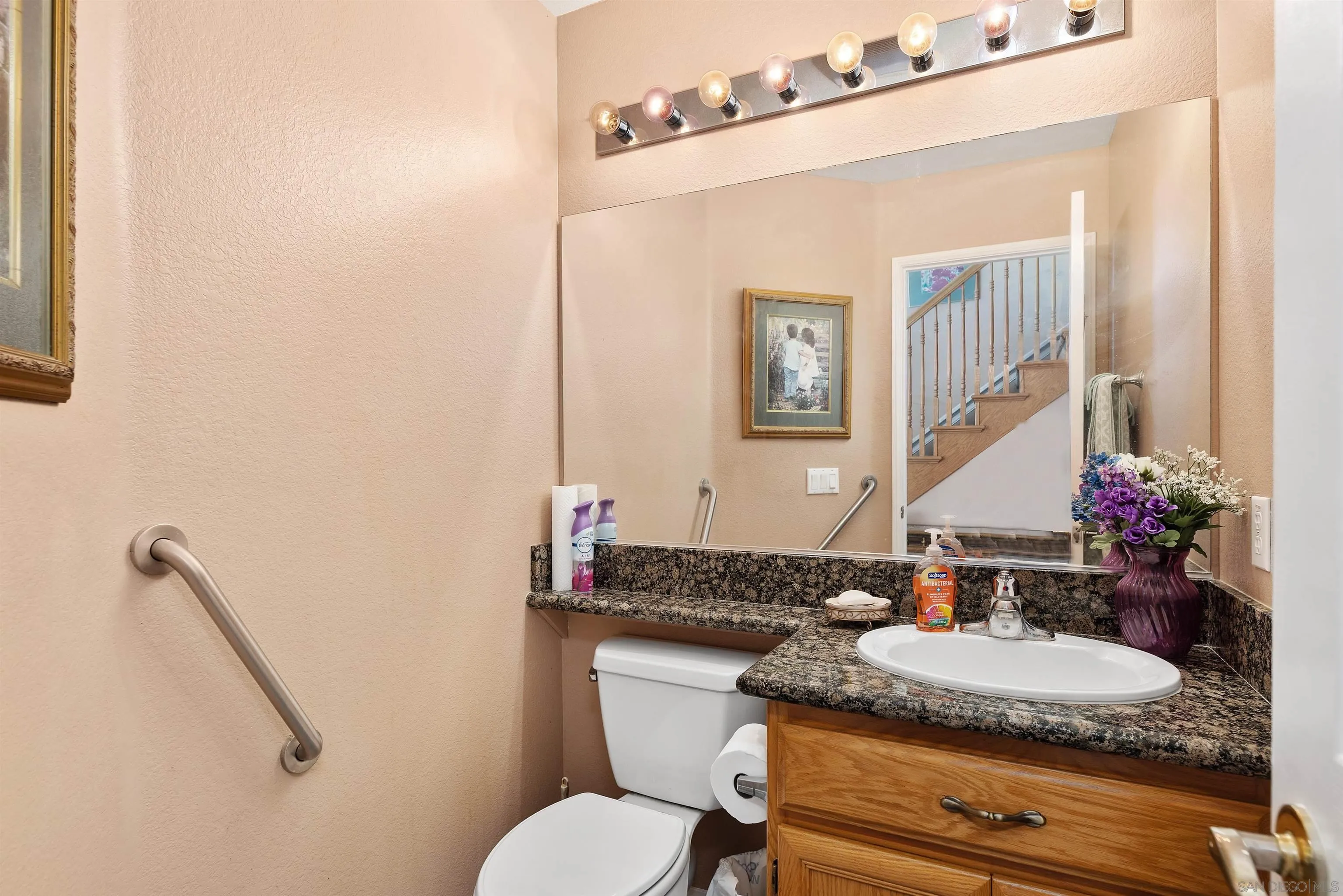 5213 Palmera Drive Oceanside, CA 92056 - Photo 19 of 38 a bathroom with a granite countertop sink and a mirror