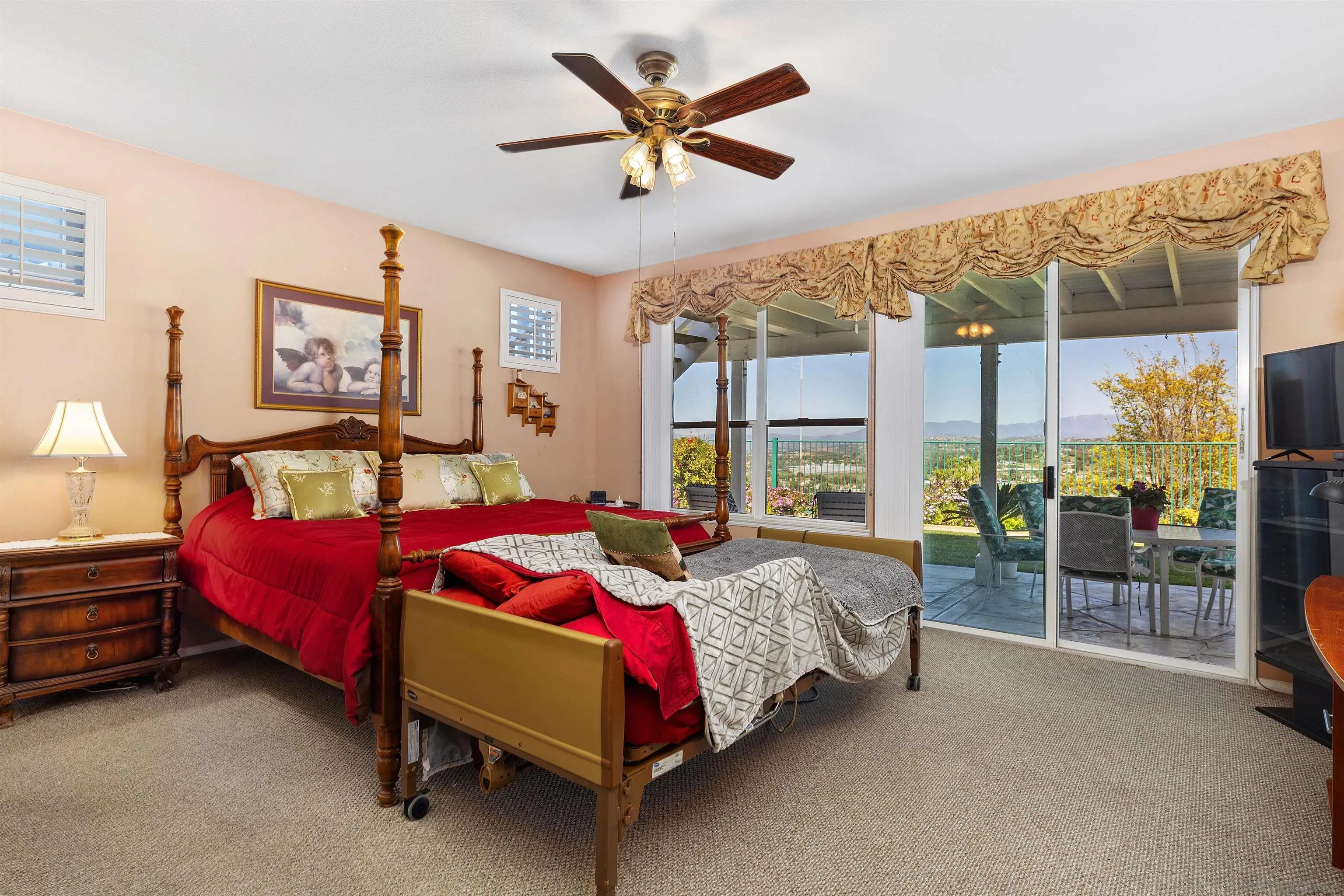 5213 Palmera Drive Oceanside, CA 92056 - Photo 20 of 38 a bedroom with a bed and a chandelier