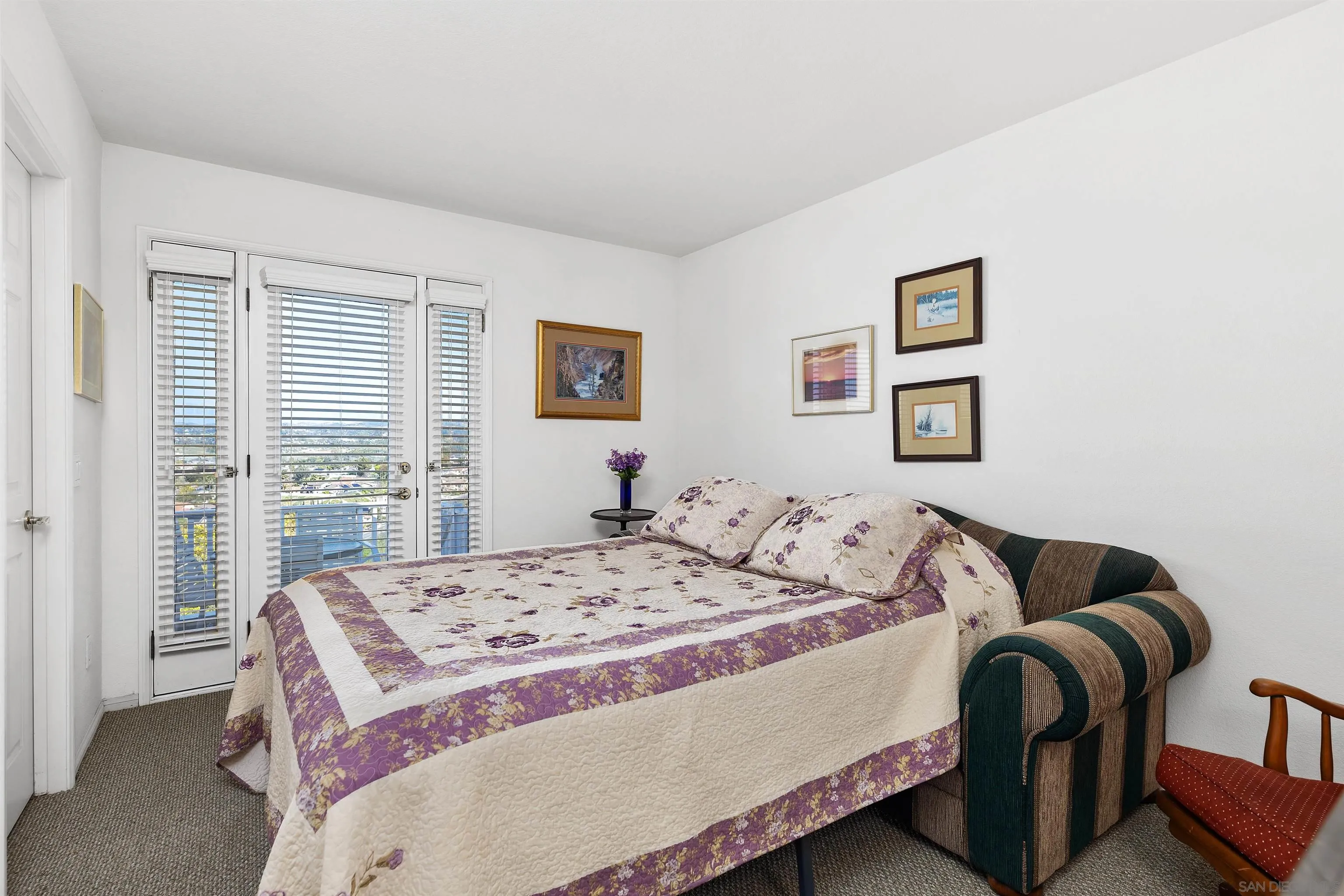 5213 Palmera Drive Oceanside, CA 92056 - Photo 28 of 38 a bedroom with a bed and wooden floor