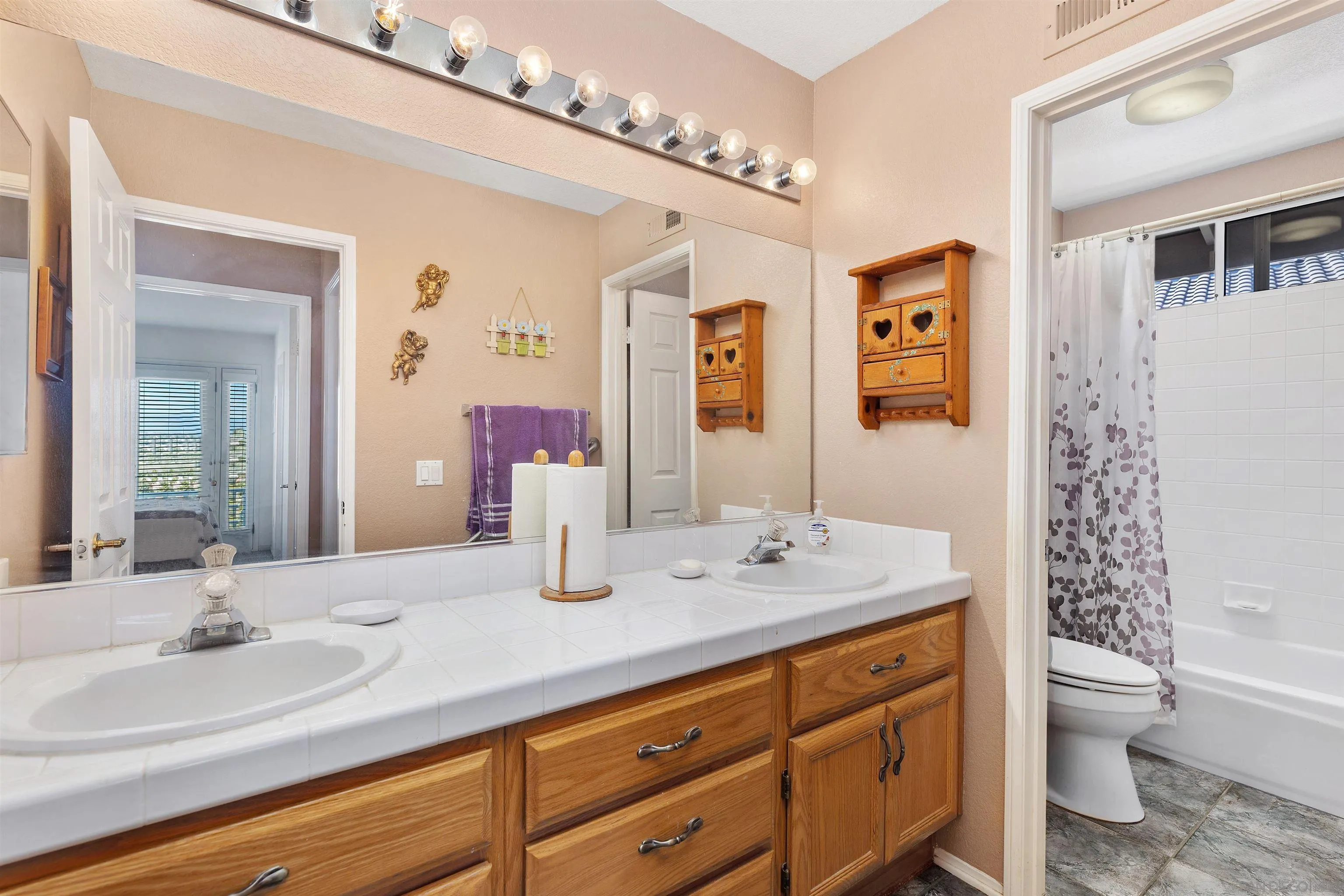 5213 Palmera Drive Oceanside, CA 92056 - Photo 30 of 38 a bathroom with a granite countertop sink mirror vanity bathtub and toilet