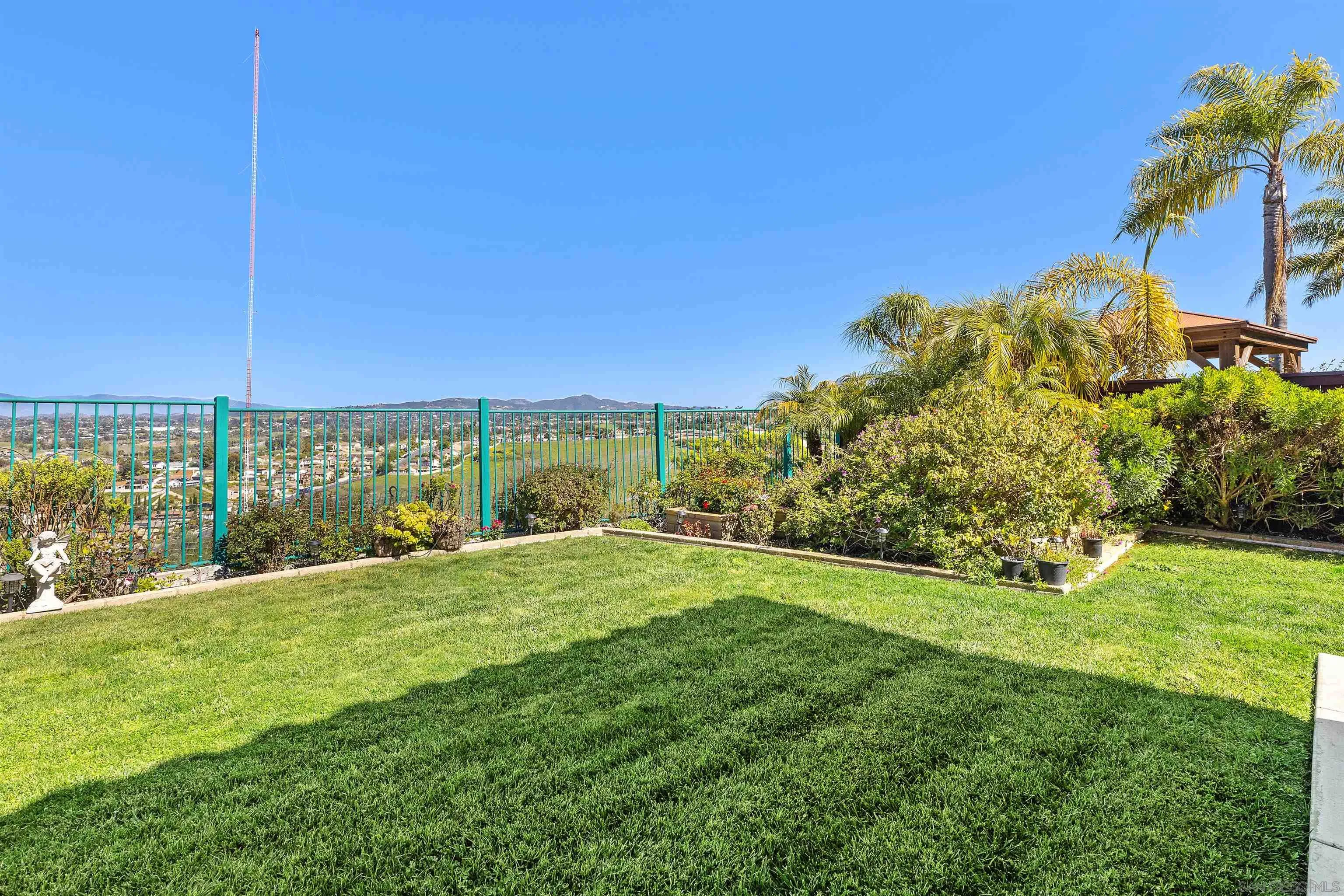 5213 Palmera Drive Oceanside, CA 92056 - Photo 37 of 38 a view of a garden with a building in the background