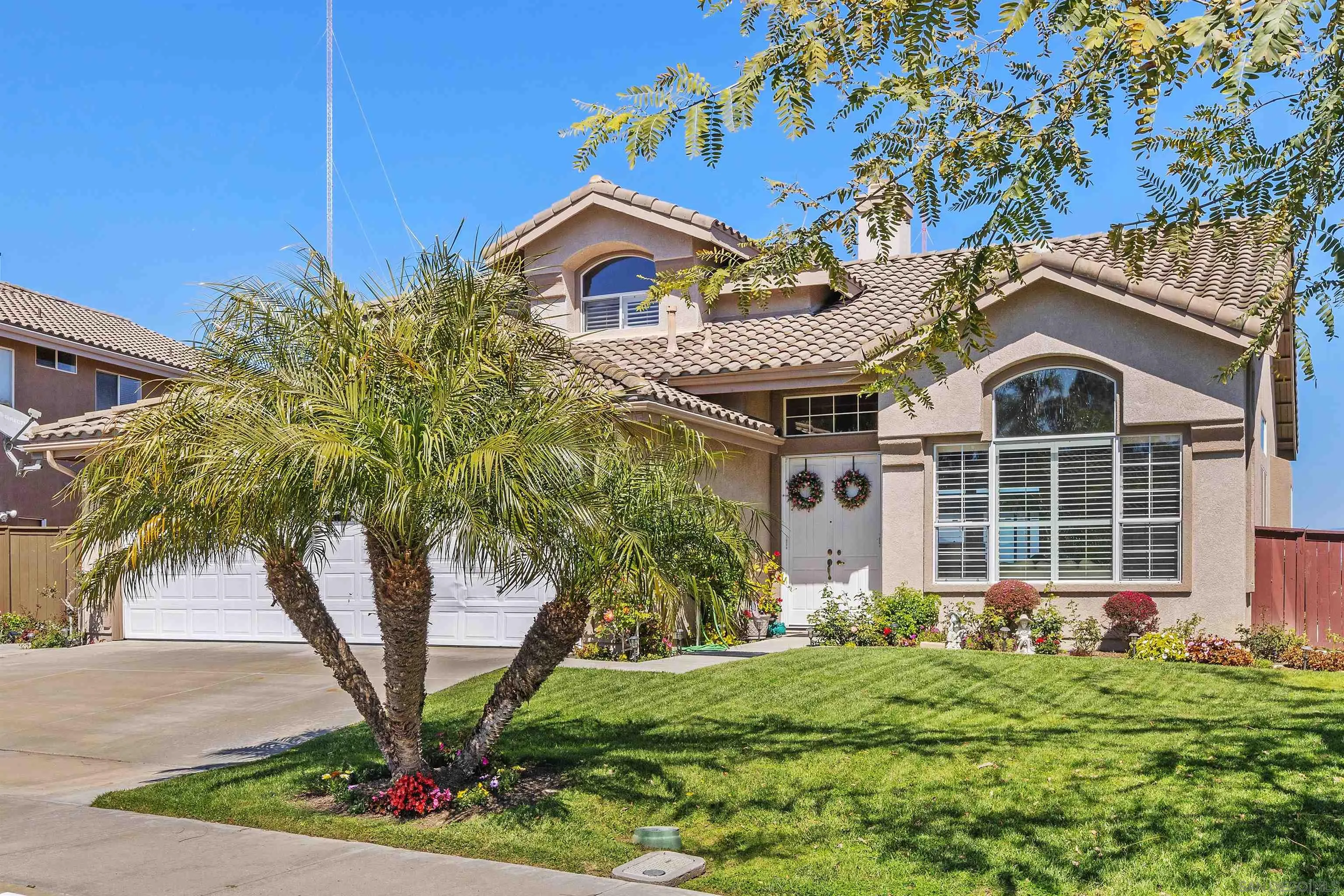 5213 Palmera Drive Oceanside, CA 92056 - Photo 4 of 38 a front view of a house with garden