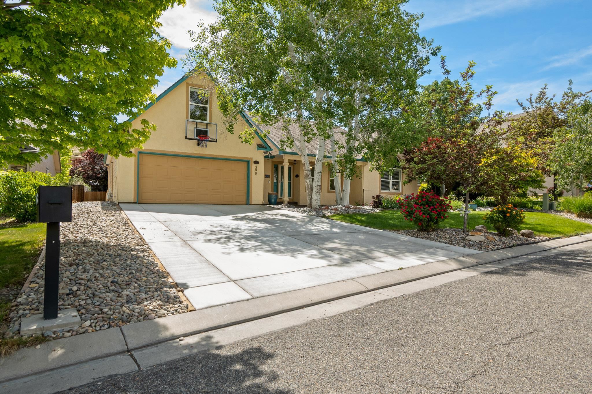 398 Butte Court Grand Junction, CO 81507 - Photo 2 of 33 a front view of a house with yard and trees