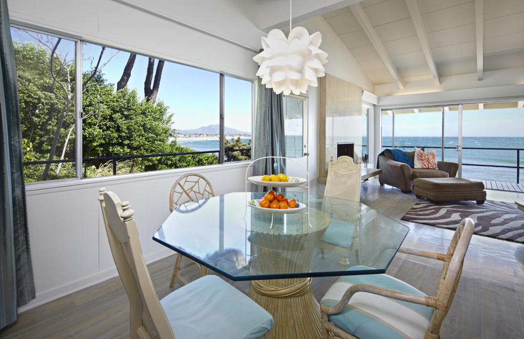 3246 Beach Club Road Carpinteria, CA 93013 - Photo 5 of 7 a view of a dining room with furniture a chandelier and large windows
