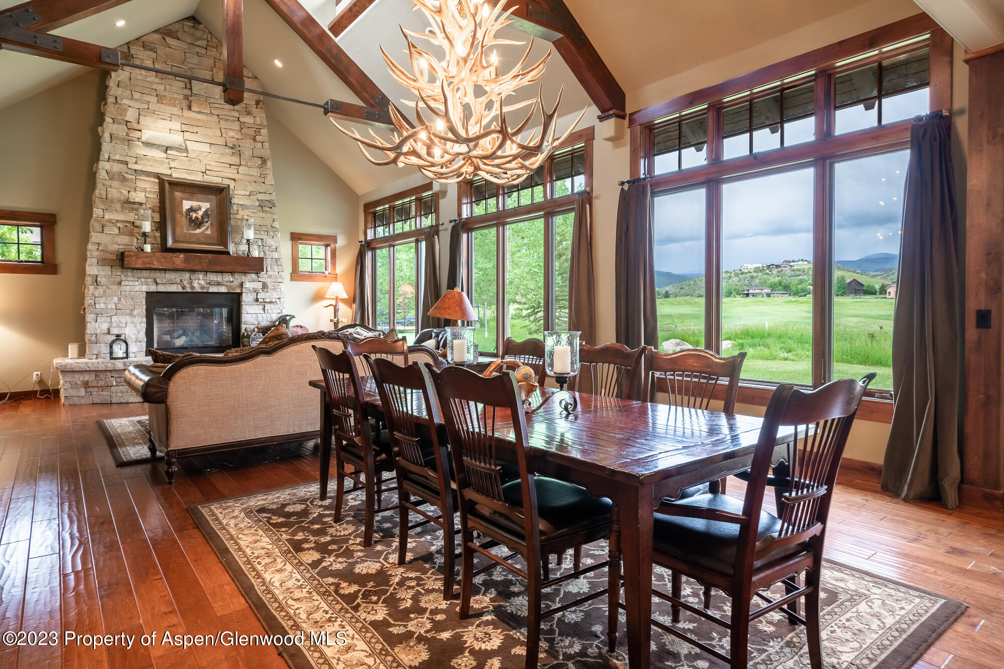 1720 Eagle Ranch Road Eagle, CO 81631 - Photo 6 of 18 a view of a dining room with furniture a chandelier and wooden floor
