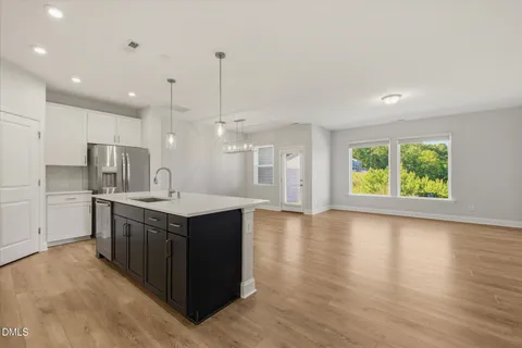 a kitchen with stainless steel appliances a refrigerator sink and stove