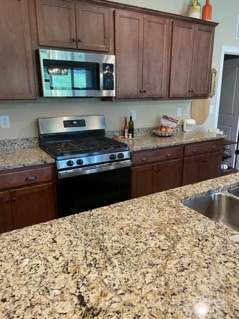 515 Bowline Drive Denver, NC 28037 - Photo 2 of 26 a kitchen with stainless steel appliances granite countertop a stove a sink and a microwave