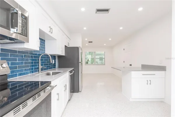 a kitchen with a sink stove and refrigerator