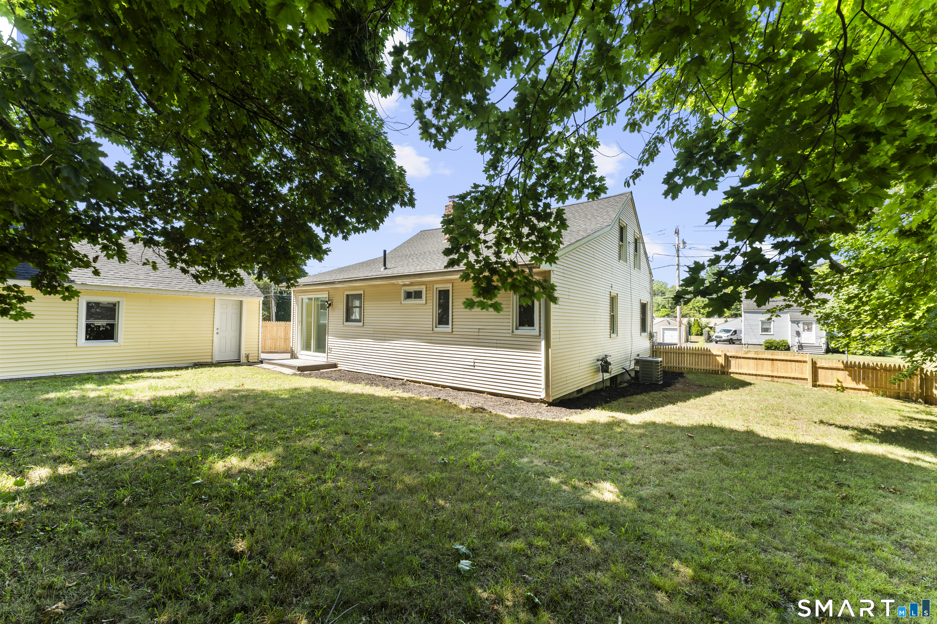 110 Minturn Road Bridgeport, CT 06606 - Photo 28 of 29 a view of a yard with a house and a large tree