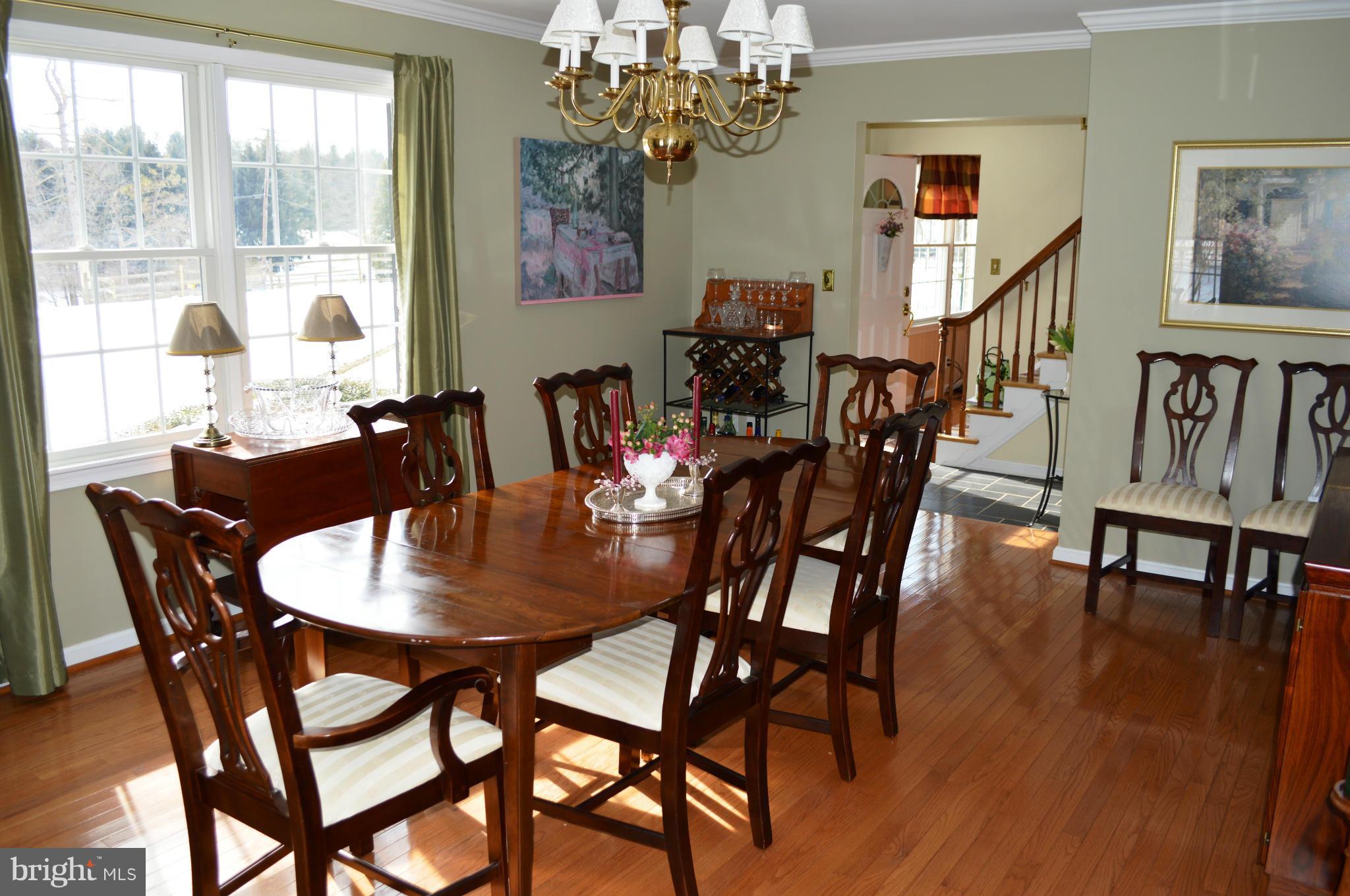 3210 Mt Zion Road Upperco, MD 21155 - Photo 5 of 30 a view of a dining room with furniture a chandelier and wooden floor