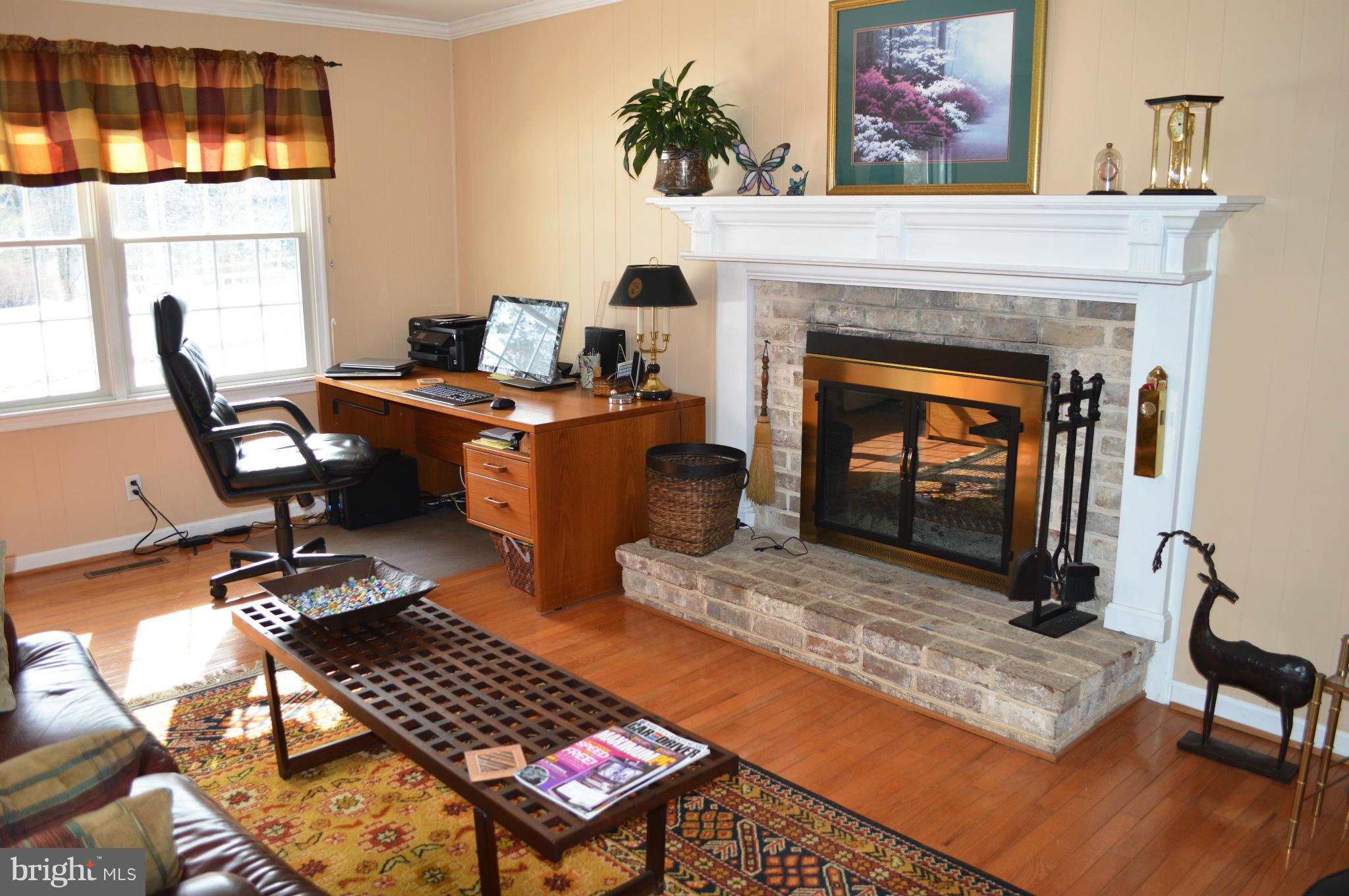 3210 Mt Zion Road Upperco, MD 21155 - Photo 8 of 30 a living room with furniture a fireplace and a flat screen tv