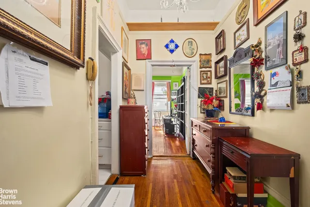 a view of a hallway with entryway wooden floor and front door