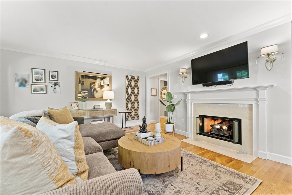 16 Preacher Road, Unit 16 Milton, MA 02186 - Photo 12 of 32 a living room with furniture a flat screen tv and a fireplace