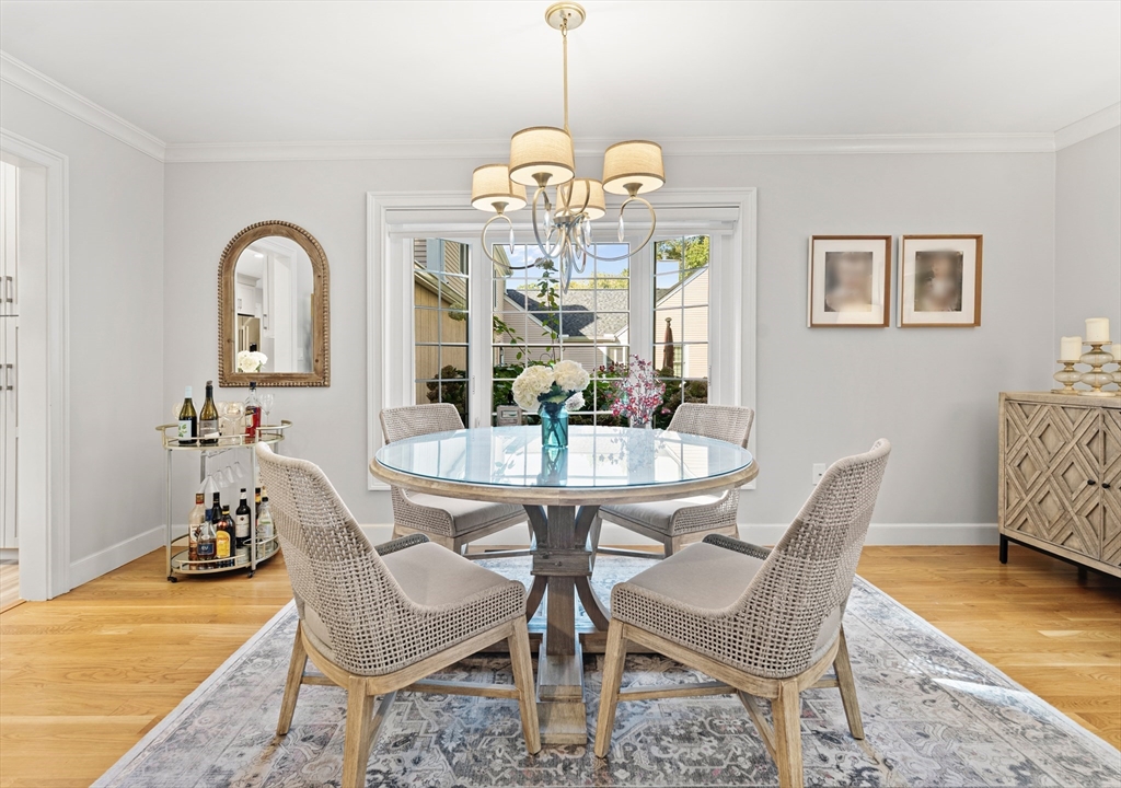 16 Preacher Road, Unit 16 Milton, MA 02186 - Photo 14 of 32 a dining room with furniture a chandelier and wooden floor