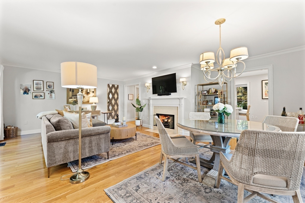 16 Preacher Road, Unit 16 Milton, MA 02186 - Photo 15 of 32 a living room with furniture a chandelier and a fireplace