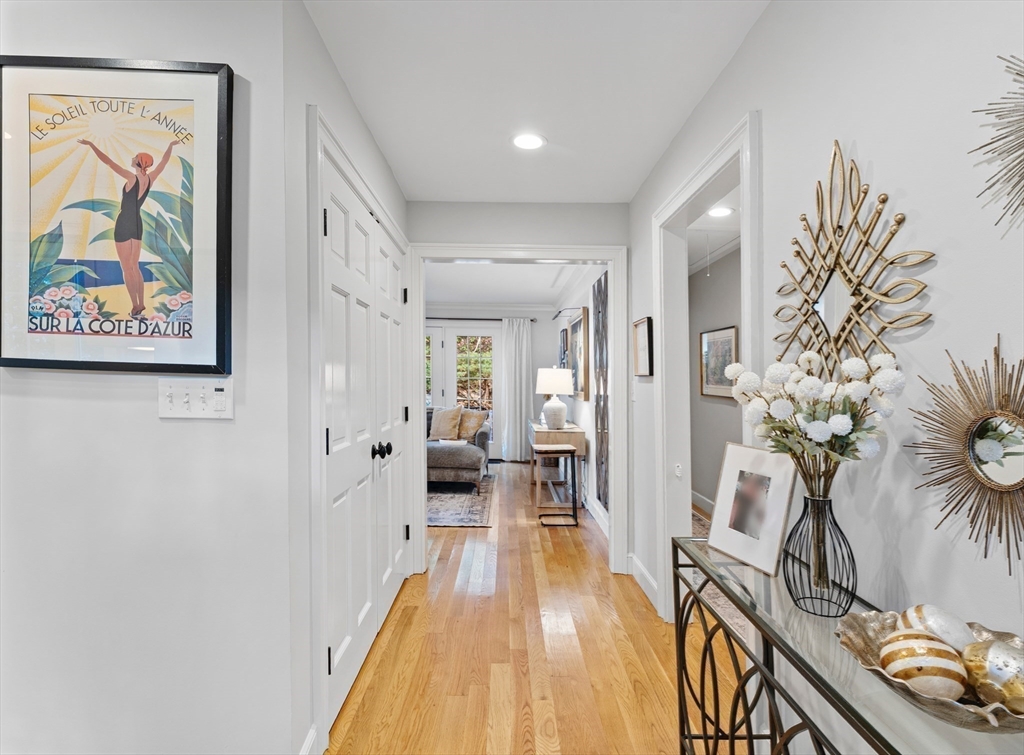 16 Preacher Road, Unit 16 Milton, MA 02186 - Photo 22 of 32 a hallway with painting on the wall and a potted plant