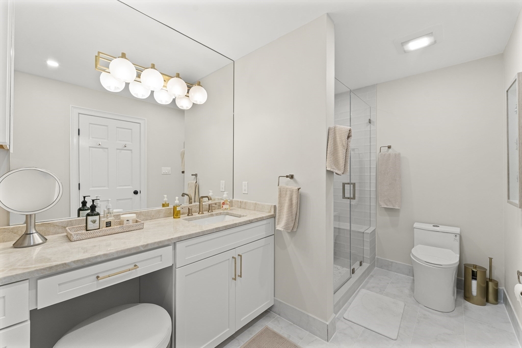 16 Preacher Road, Unit 16 Milton, MA 02186 - Photo 31 of 32 a bathroom with a toilet a sink and mirror